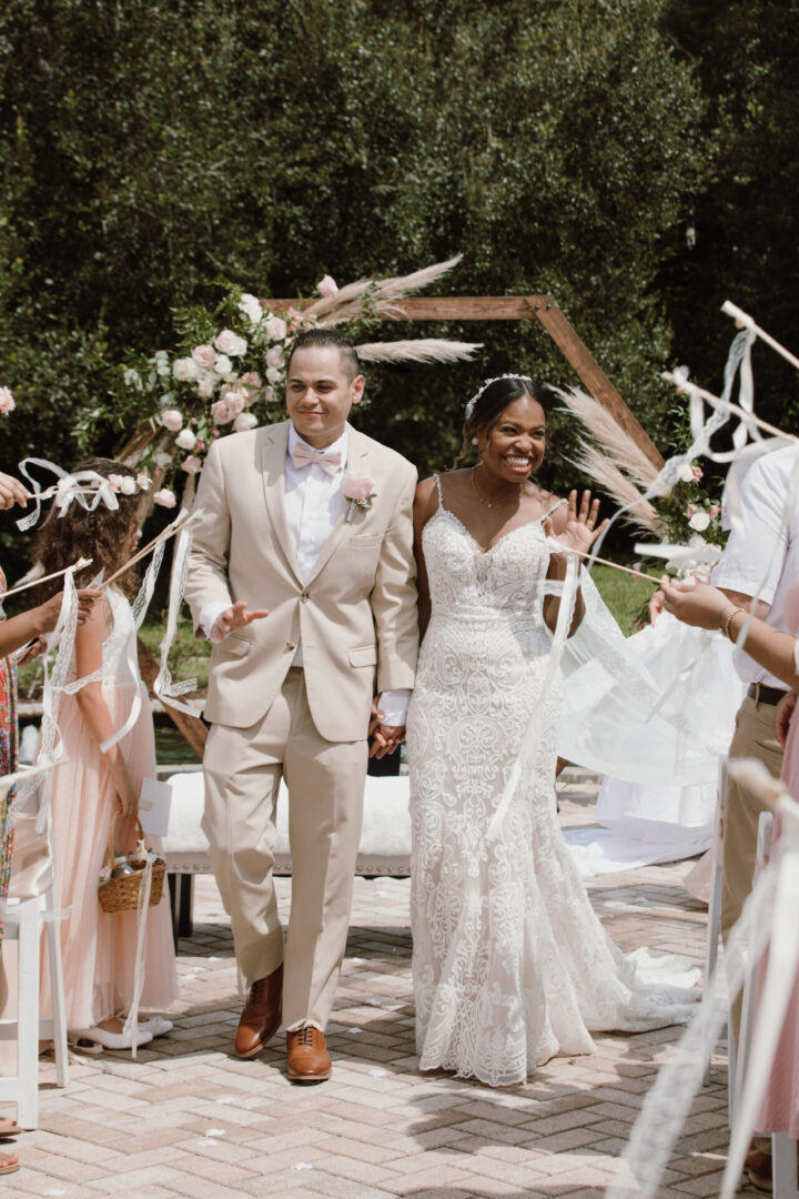 A man and woman walking down the aisle.