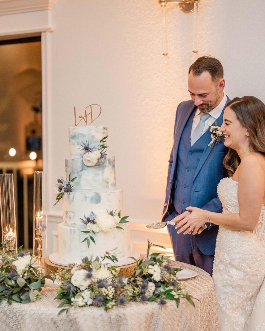 A bride and groom cutting their wedding cake.