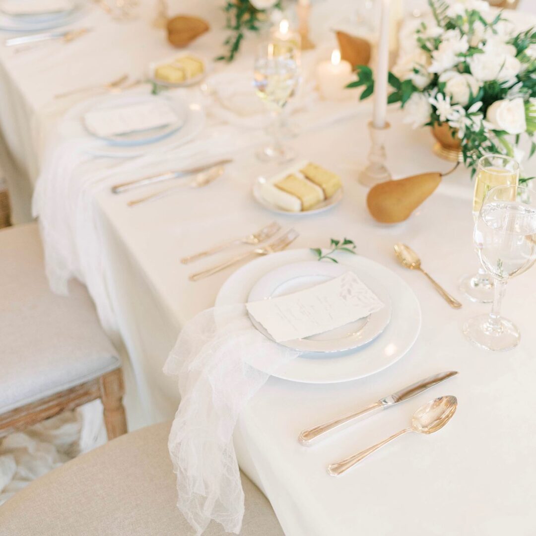 A White Themed Table With Ceramic Plates