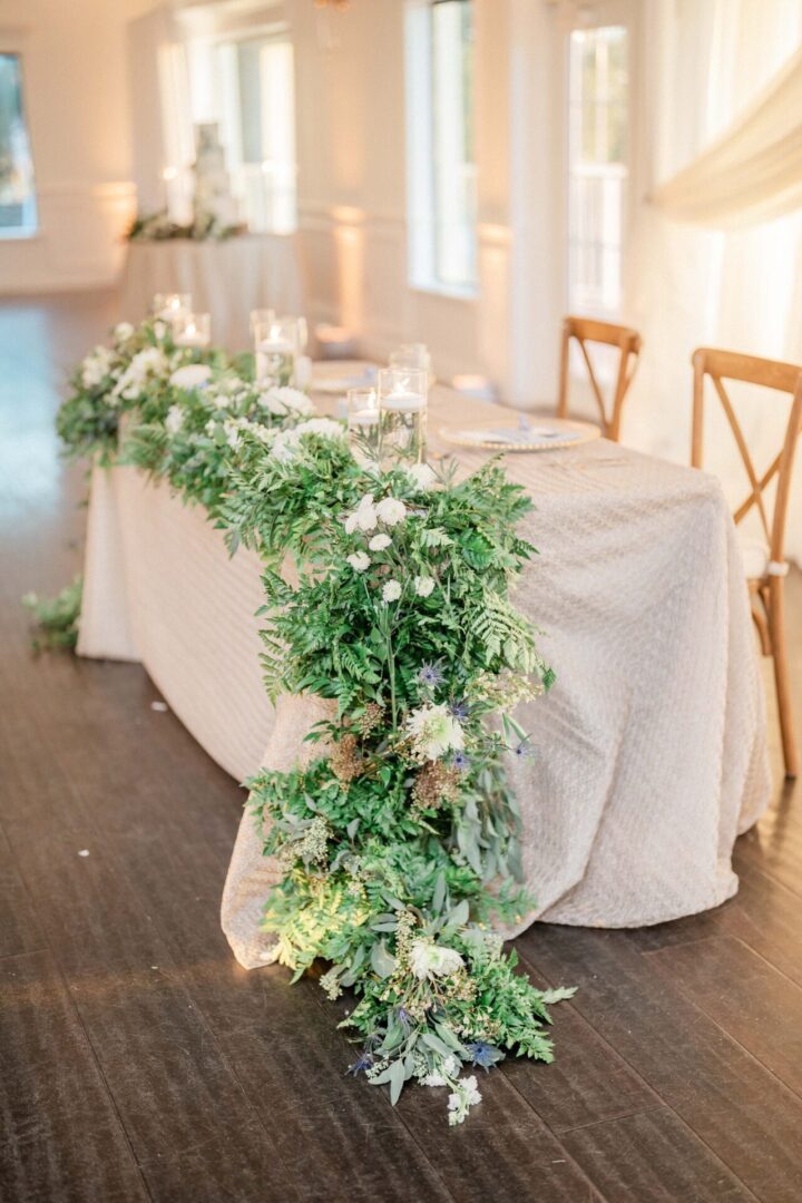 A Table With a Lines of Leaves and Flowers