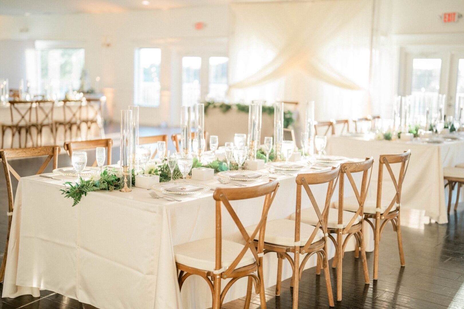 A White Themed Table With Wooden Chairs