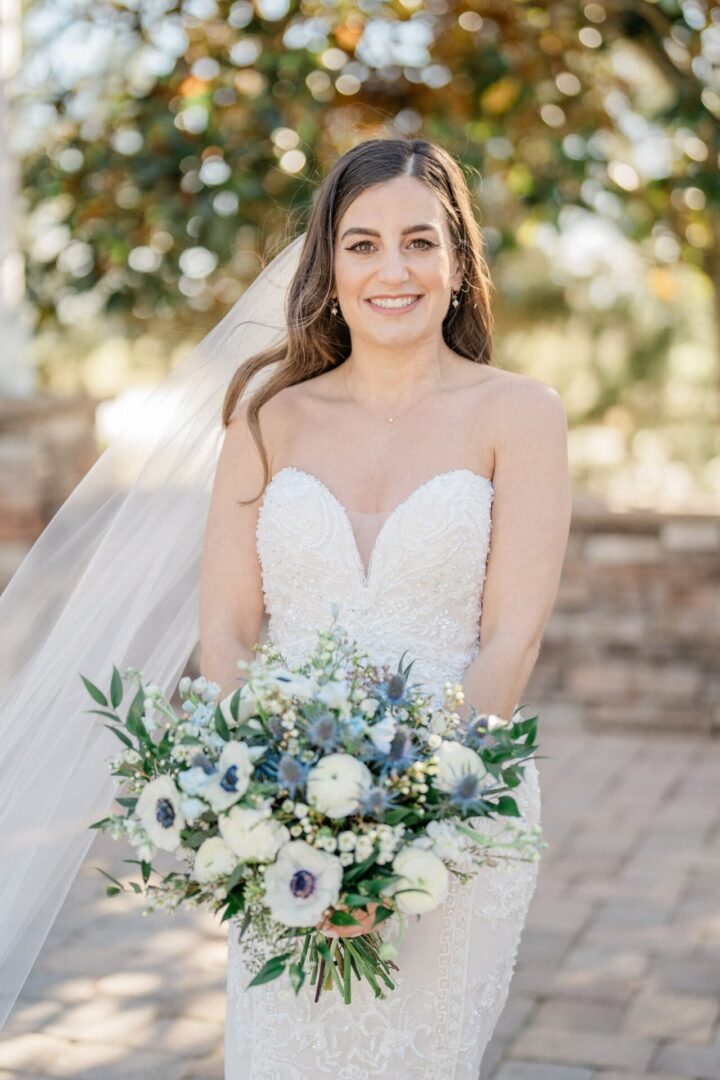 A Bride Holding a Blue and White Color Flower Bunch