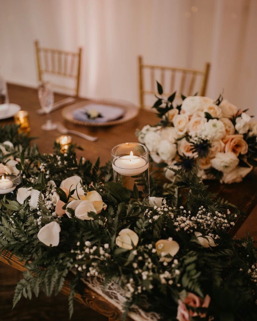 Candles and Roses Placed on a Table