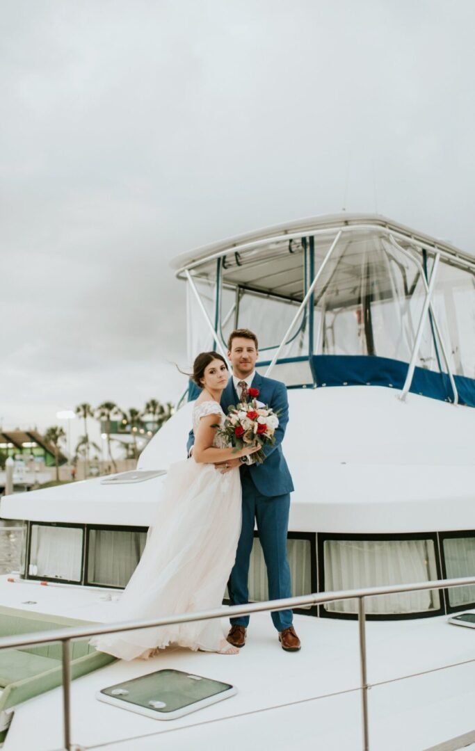 A Bride and Groom Posing on the Deck of a Boat