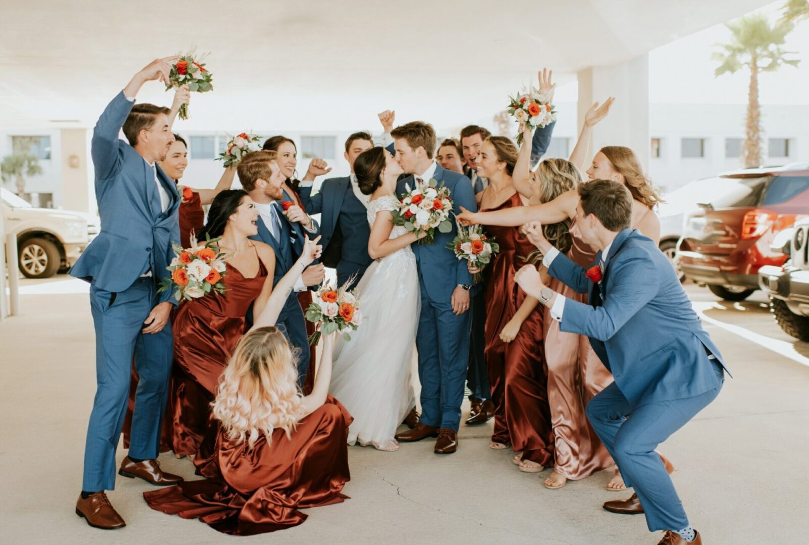 A Bride and Groom Kissing Around a Group of Guests