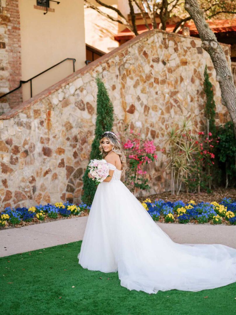 A bride in her wedding dress posing for the camera.