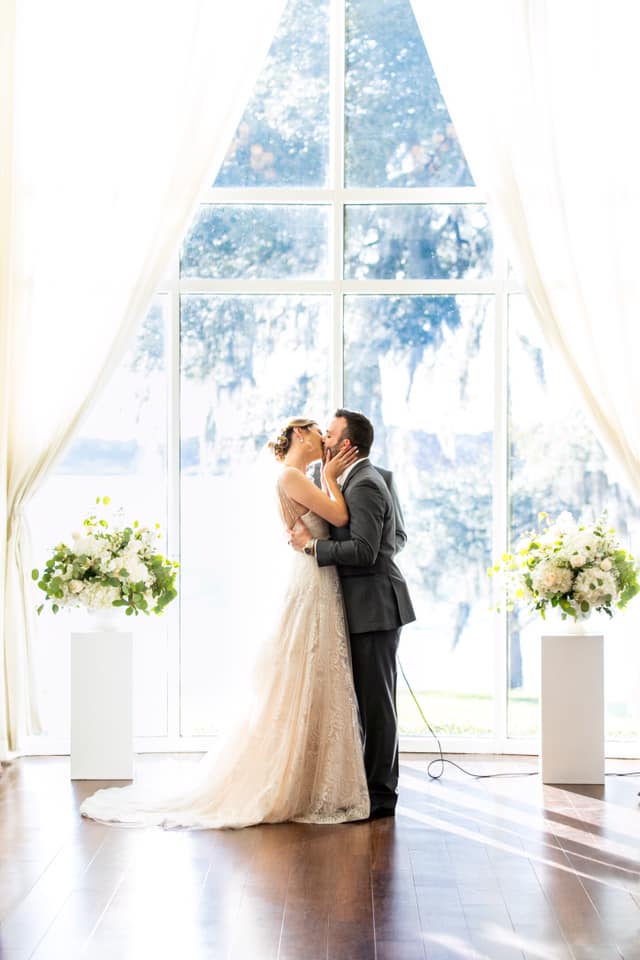 A Couple Kissing by Long Glass Doors