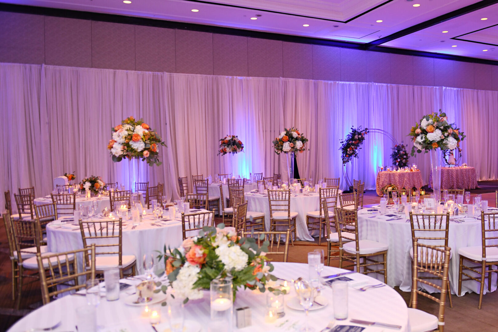 A Wedding Venue Decor With Brass Chairs