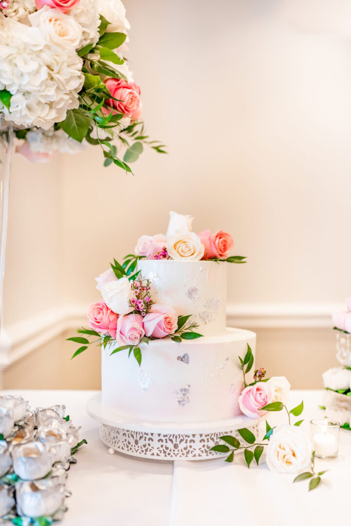 A Two Tiered Cake With Flowers Decoration