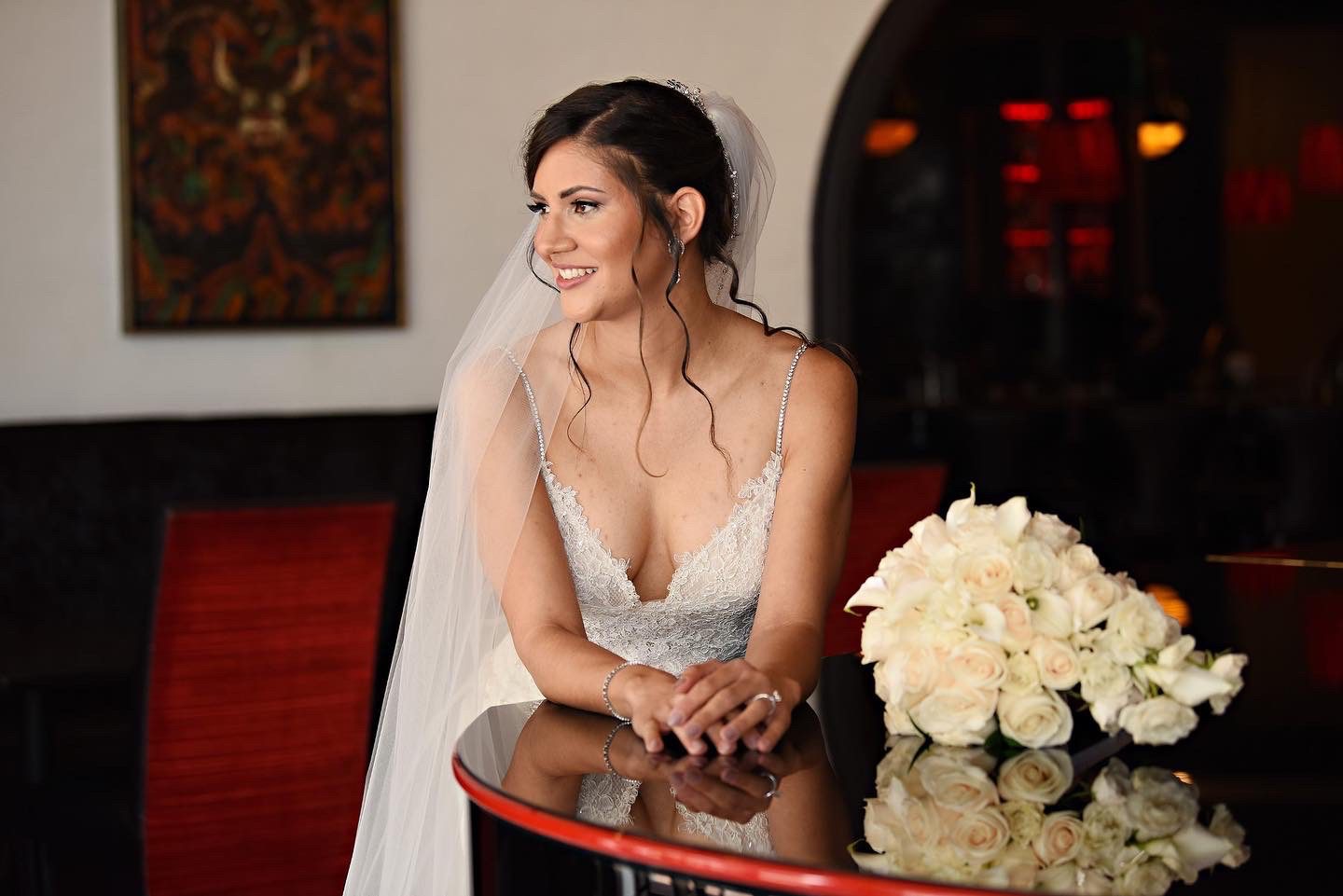 A Bride Leaning on a Table With a Bouquet
