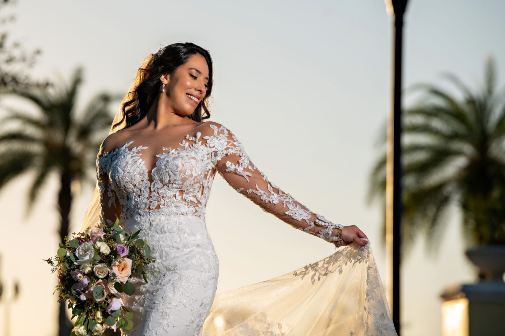 A woman in a white dress holding onto a bouquet of flowers.