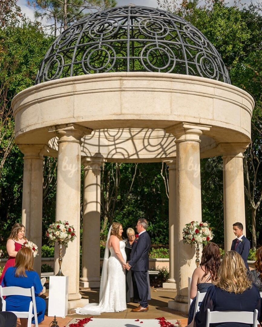 Bride and Groom Standing Under a Dome