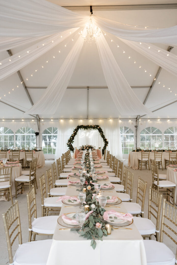 A Long Table With Chairs Under a Tent